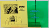 A vinyl record package shown flat against a white background, featuring a yellow cover with black line art and the text 'SPOWDER joy cleaner,' alongside a bright green translucent record and track listing details.