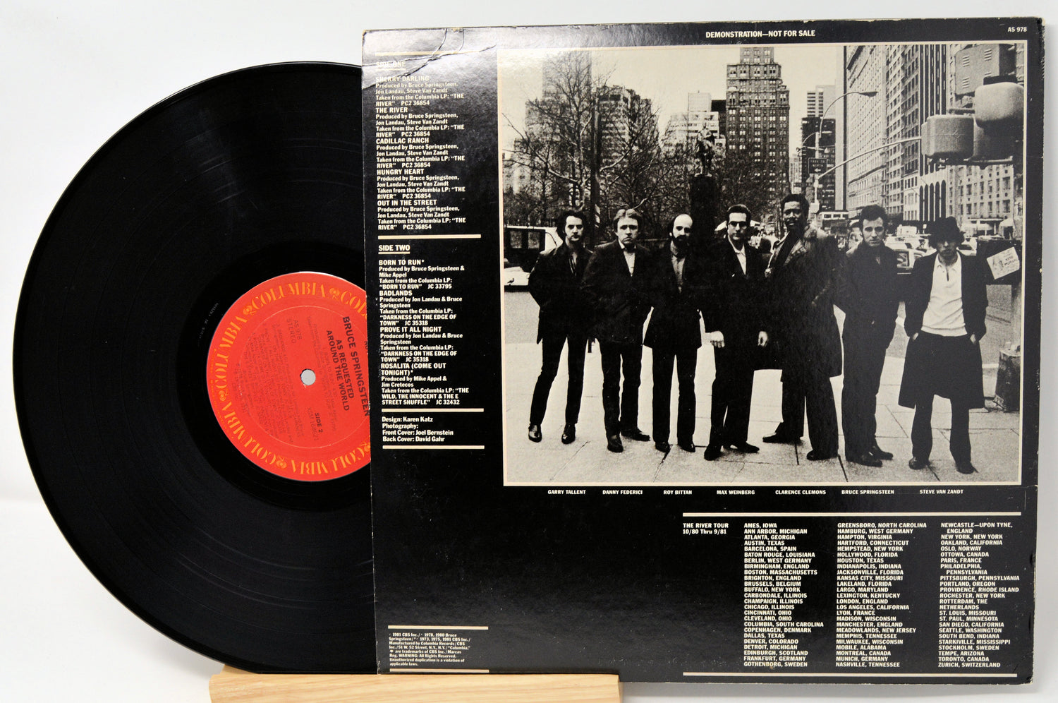 Vinyl record with cover featuring a black and white photo of a group of people in suits.