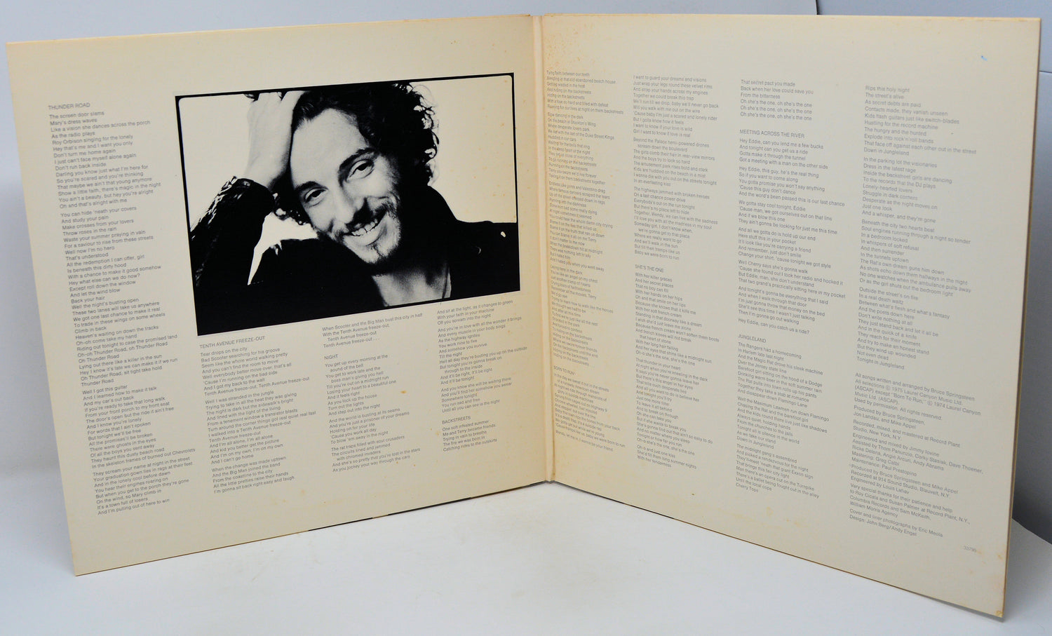 Album cover with a black and white photo of a person on a beige background