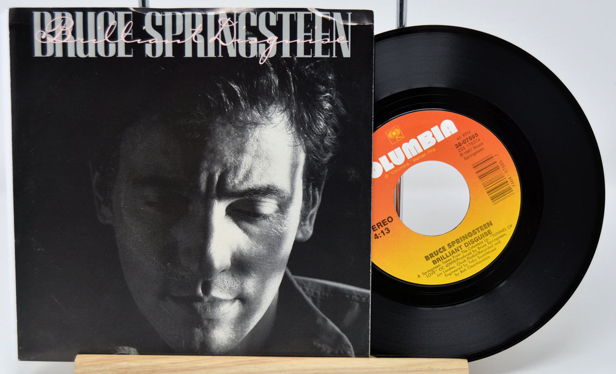 Vinyl record and cover featuring Bruce Springsteen on a white background