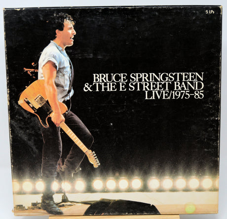 Vinyl album cover featuring Bruce Springsteen with a guitar, set against a dark background with bright lights at the bottom.