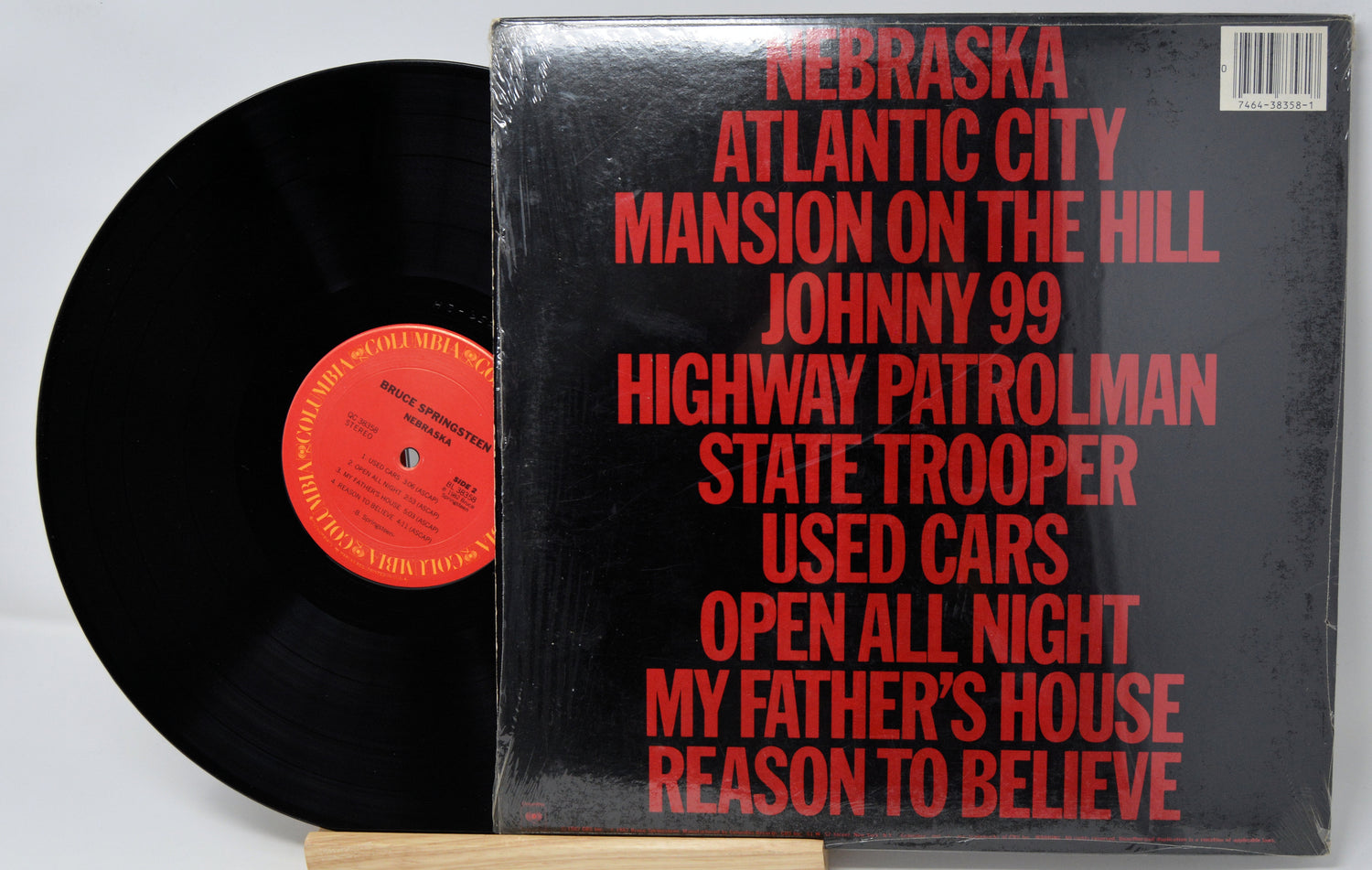 Vinyl record with red text on a black cover against a white background