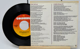 Vinyl record with Columbia label and Bruce Springsteen song lyrics on a white background