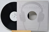 Vinyl record with a cover featuring headphones and 'Radio Broadcast' text on a white background