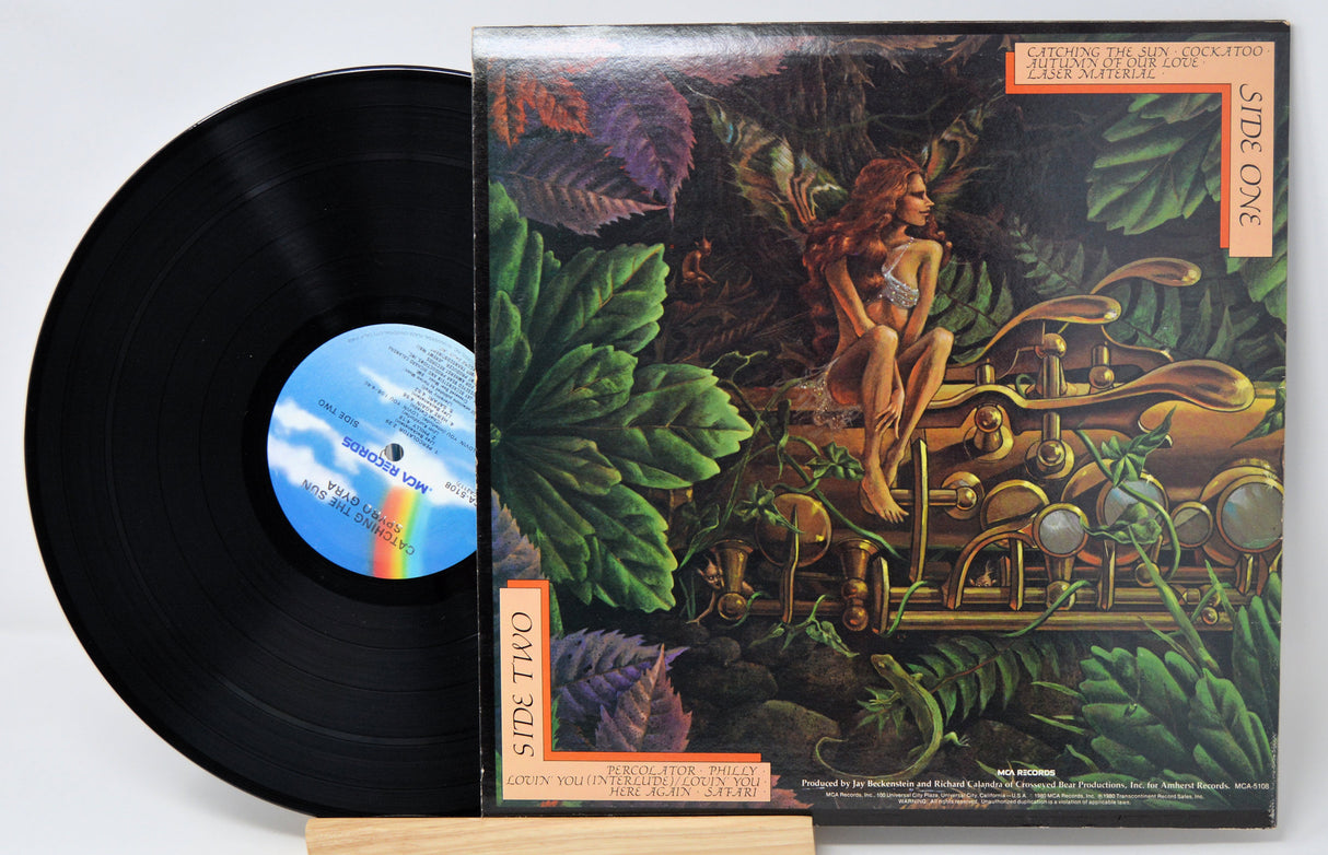 Vinyl record 'Spyro Gyra Catching The Sun'  with colorful cover featuring a woman and nature elements on a white background