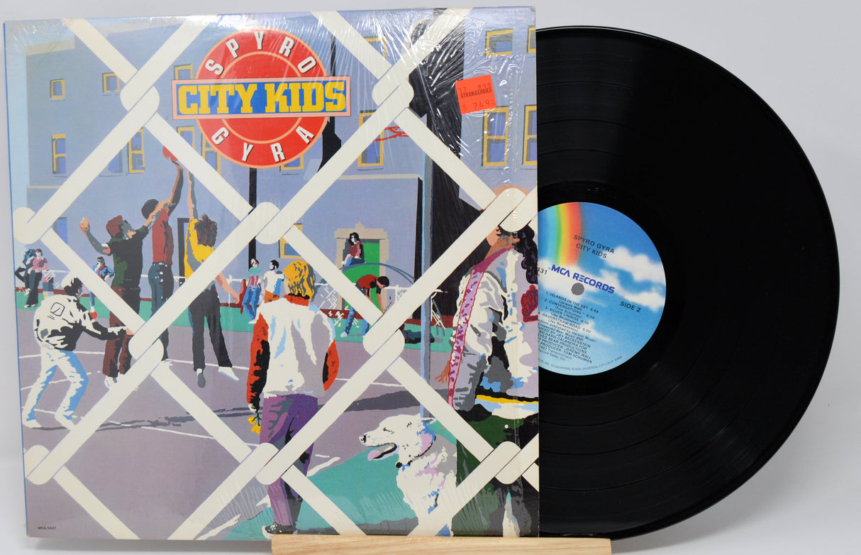 Vinyl record with colorful cover featuring 'Spyro Gyra City Kids' and a white background