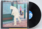 'Spyro Gyra Incognito' Vinyl record with cover featuring a stylized illustration of a person and a dog on a street.