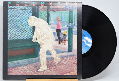 'Spyro Gyra Incognito' Vinyl record with cover featuring a stylized illustration of a person and a dog on a street.