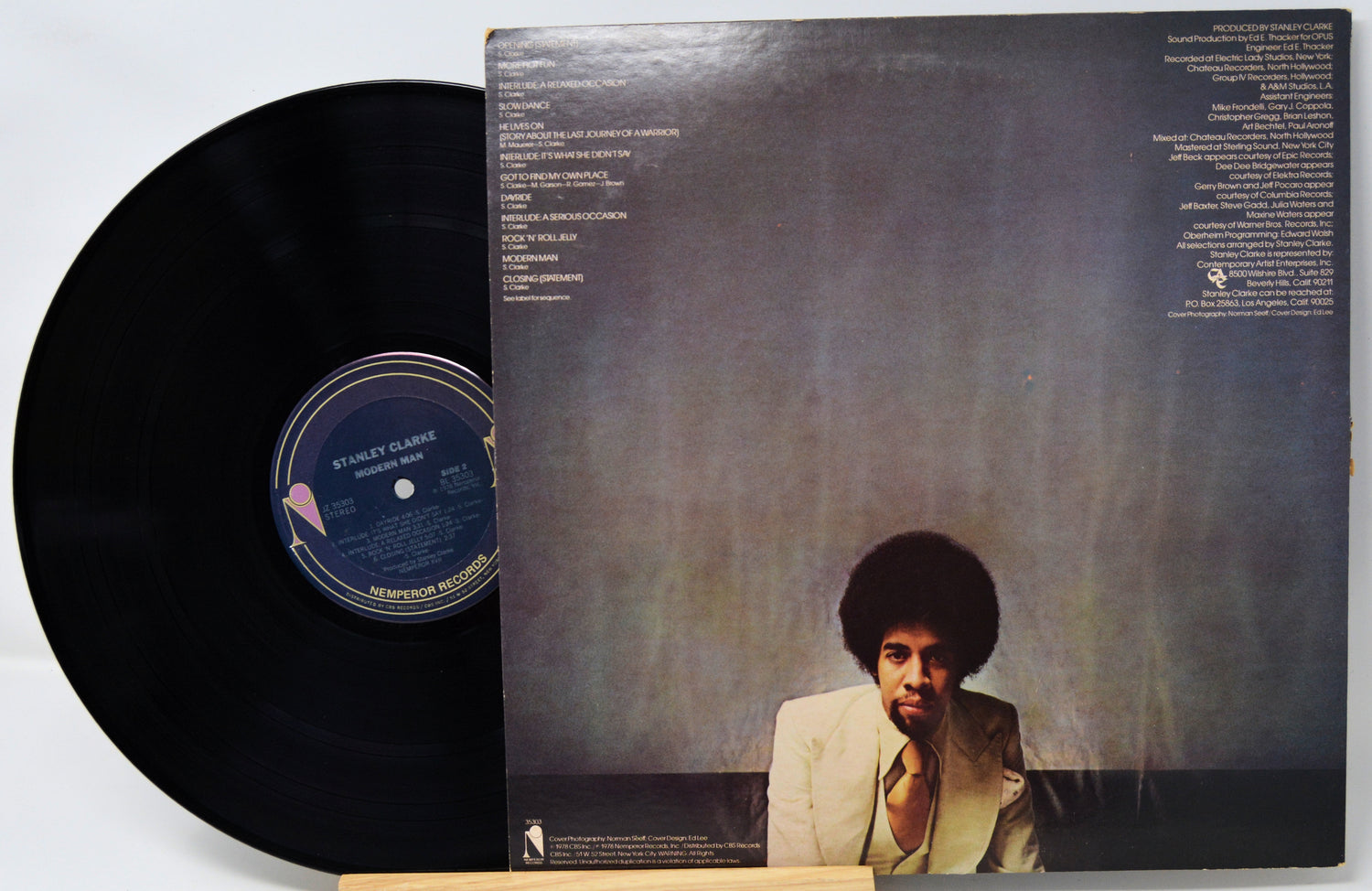 Vinyl record with cover featuring a person against a textured background