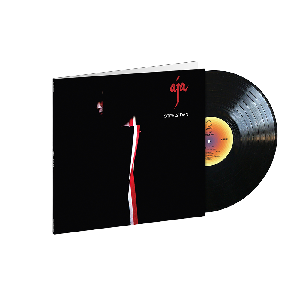 A vinyl record of the album 'Aja' by Steely Dan, featuring a black cover with a simple red design.