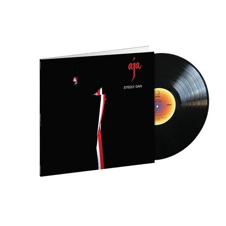 A vinyl record of the album 'Aja' by Steely Dan, featuring a black cover with a simple red design.