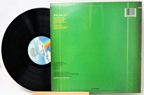 Vinyl record with green cover and blue label on a white background
