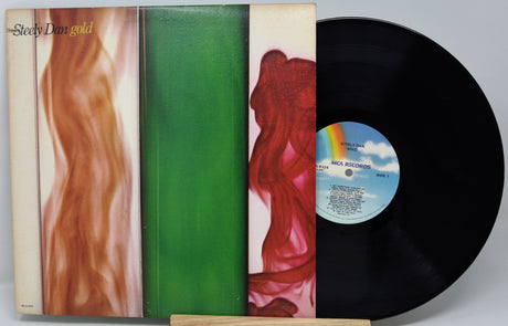 Vinyl record with colorful cover and visible label on a gray background