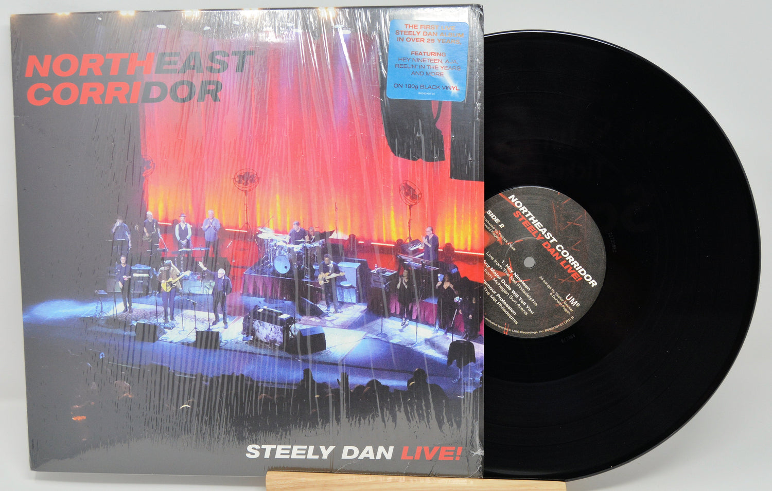 Front cover and vinyl record of Steely Dan's Northeast Corridor Live! album showing a concert stage with band