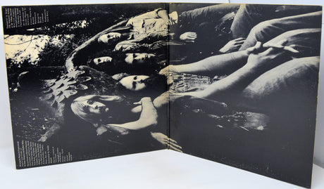 Black and white album cover with a group of people lying down.