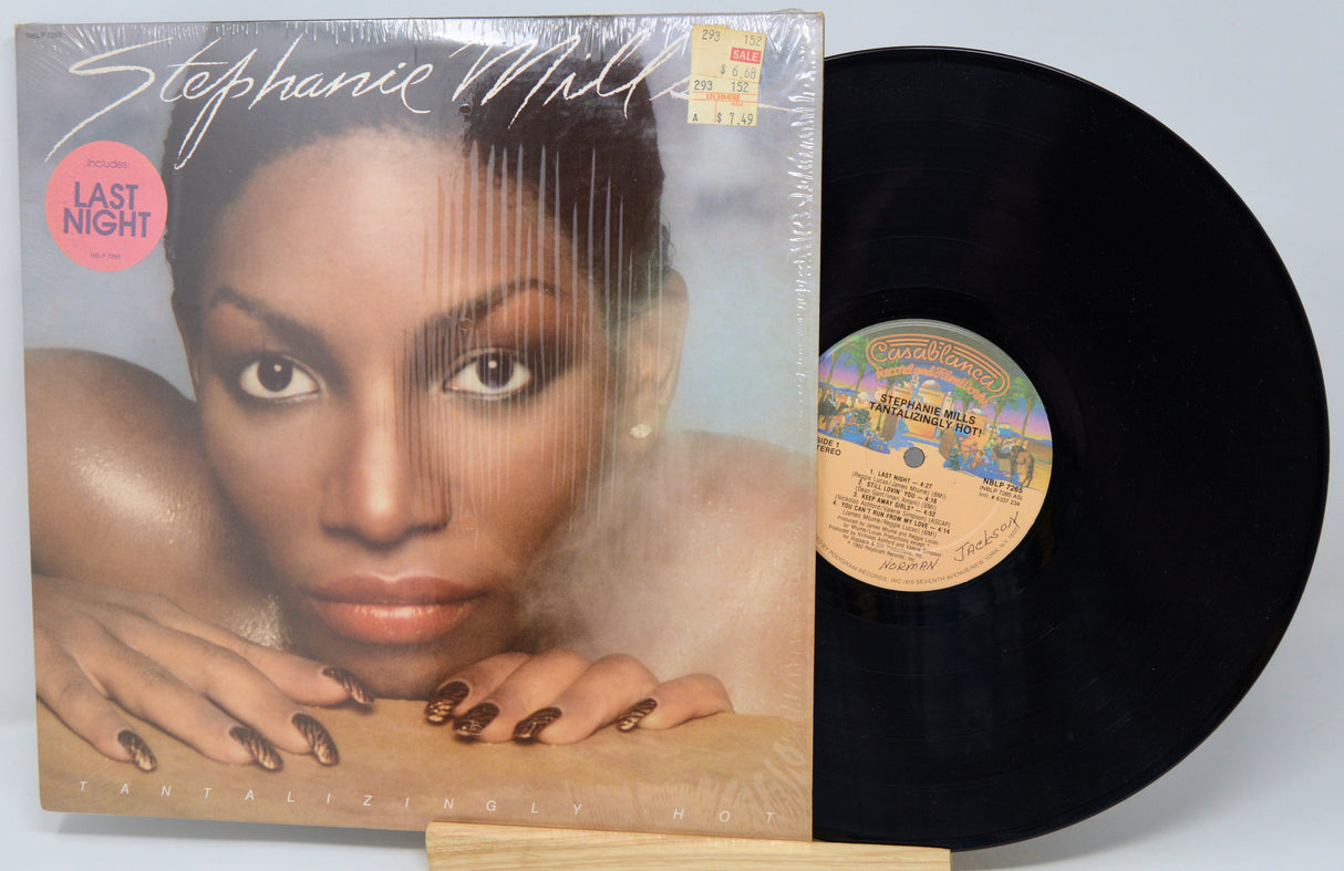 Vinyl record with cover featuring a woman's face and album details.