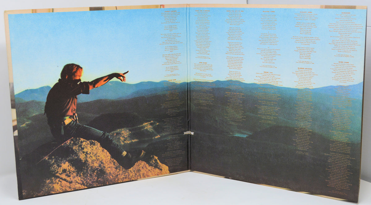 Album cover with a person on a mountain peak and text overlay