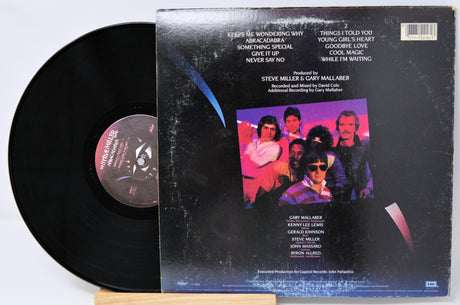 Vinyl record with cover featuring a band photo and text on a white background
