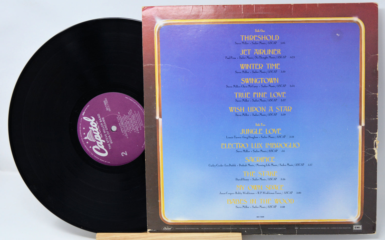 Vinyl record with a blue label featuring track listings on a white background