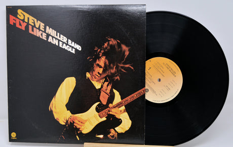 Vinyl record with cover featuring a musician playing guitar, titled 'Fly Like an Eagle' by Steve Miller Band.