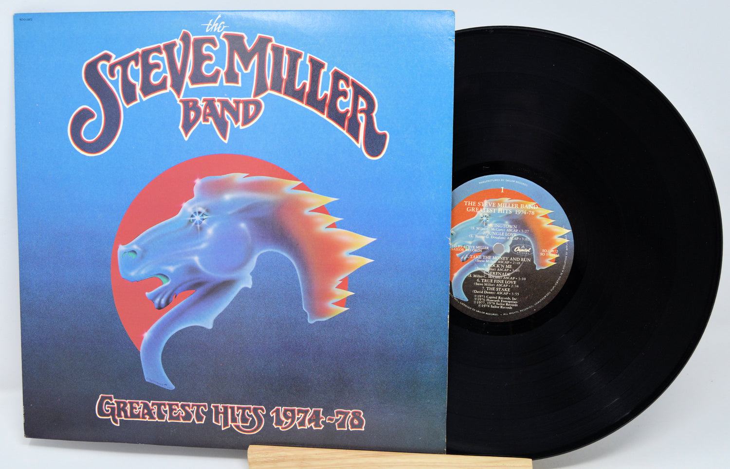 Vinyl record with 'The Steve Miller Band Greatest Hits 1974-76' on a blue background