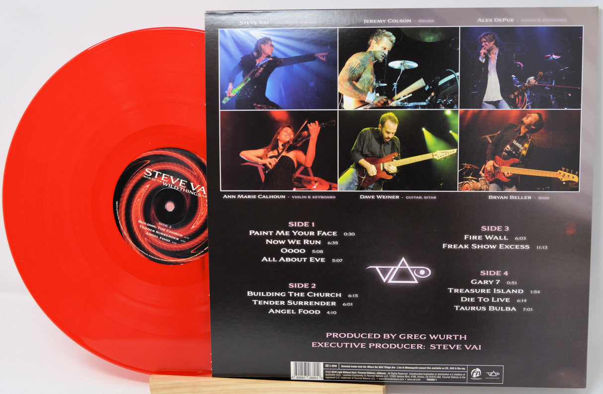 Steve Vai 'The Wall' vinyl record LP shown with the red translucent record partially visible behind the back cover of the sleeve, photographed on a light neutral background.