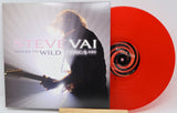 Steve Vai 'Where the Wild Things Are' vinyl record with the album cover standing beside a bright red translucent record on a white background.