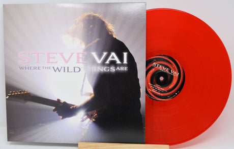 Steve Vai 'Where the Wild Things Are' vinyl record with the album cover standing beside a bright red translucent record on a white background.