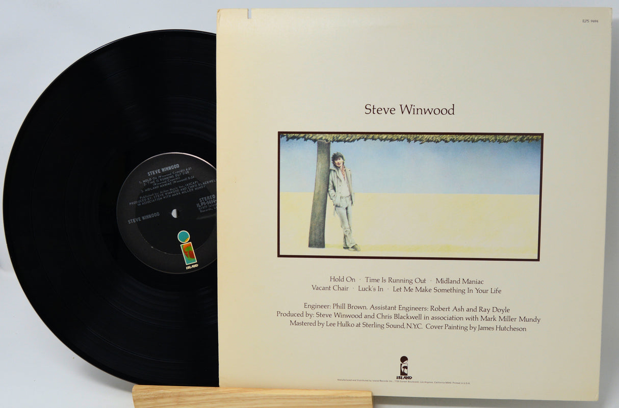 Vinyl record with blue cover featuring text and a red illustration on a white background