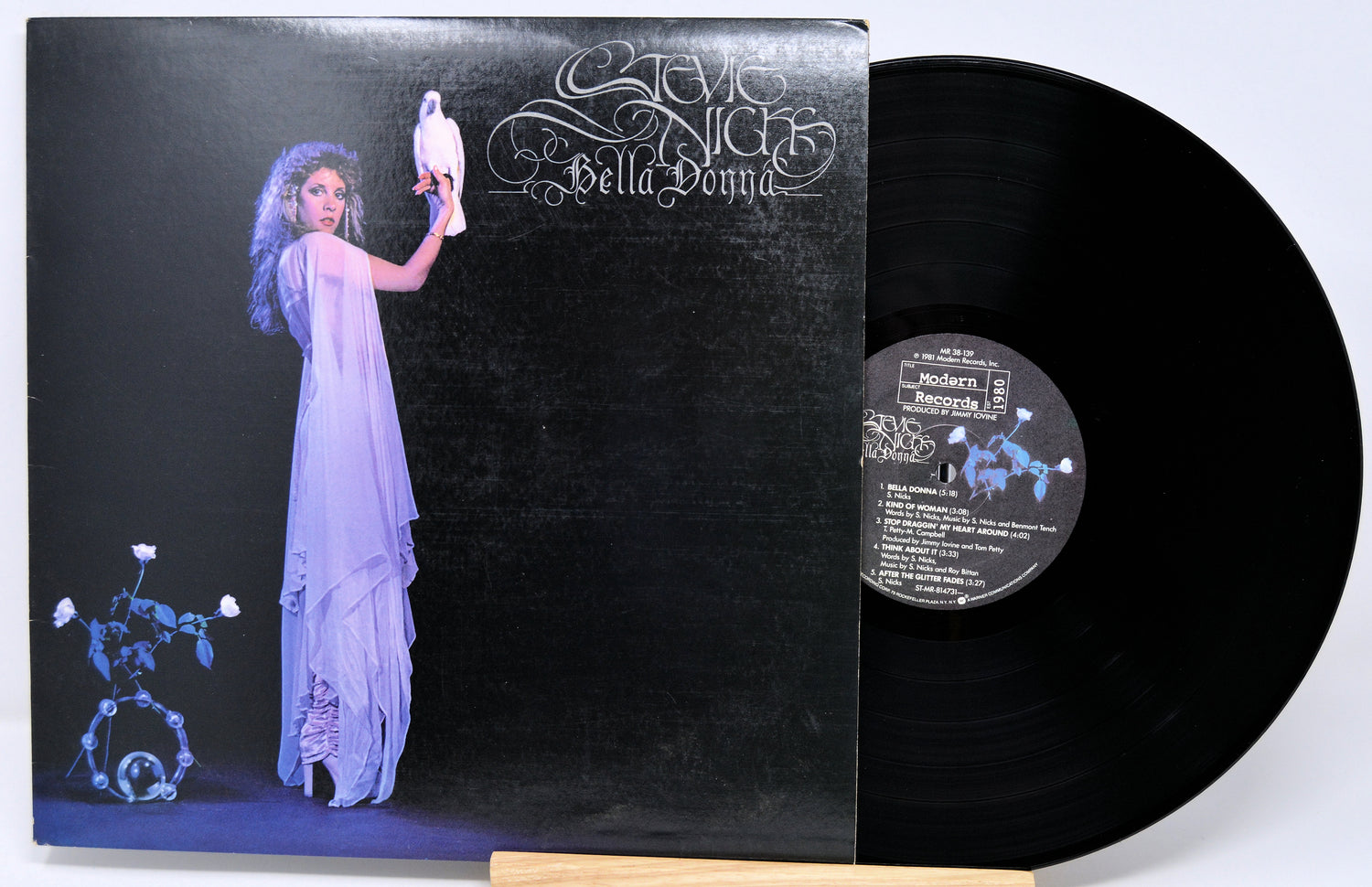 Vinyl record with a cover featuring an artistic design of a woman and a bird.