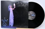 Vinyl record with a cover featuring an artistic design of a woman and a bird.