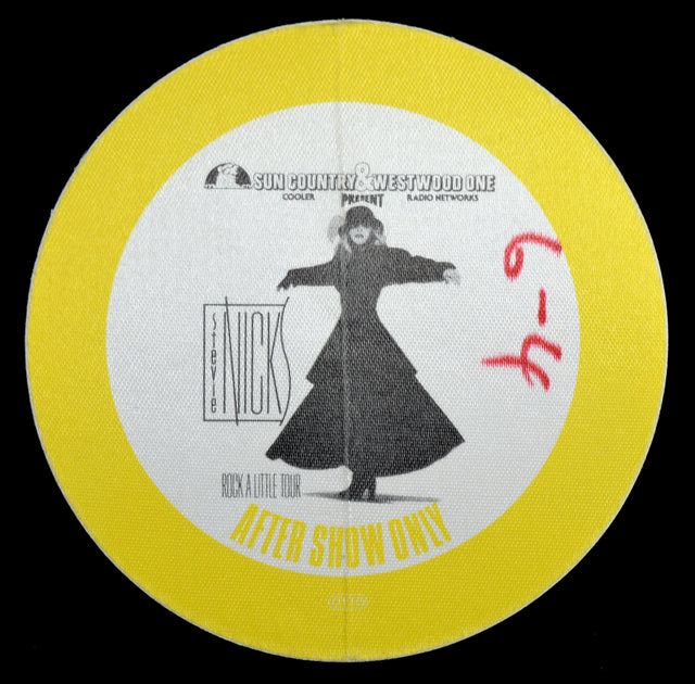 Stevie Nicks backstage pass for the Rock A Little tour showing a picture of her in a long coat and text on a yellow border