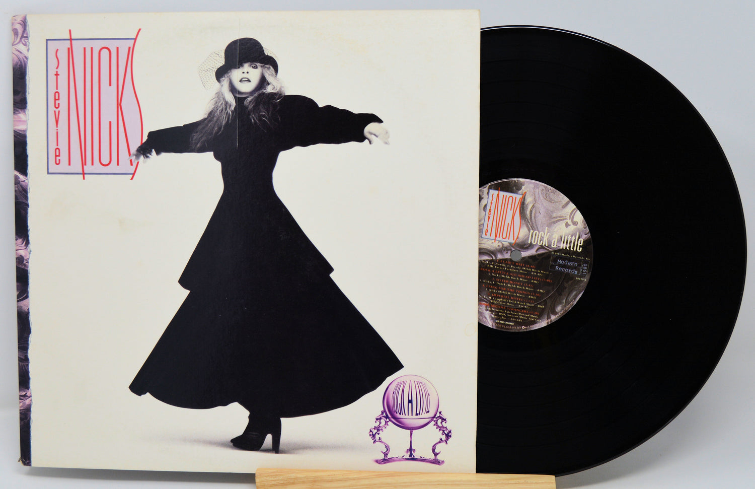 Vinyl record with cover featuring a stylized image of a woman in a long dress and hat.