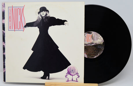 Vinyl record with cover featuring a stylized image of a woman in a long dress and hat.