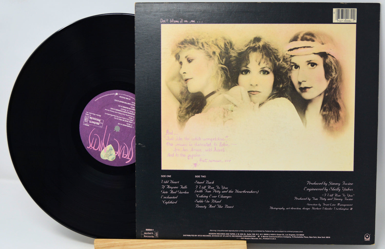 Vinyl record with a black cover featuring three women and a purple label.