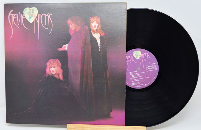 Vinyl record with cover featuring a purple-themed design and text.