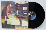 Vinyl record with front cover featuring a musician and album title 'Couldn't Stand the Weather' by Steve Ray Vaughan.