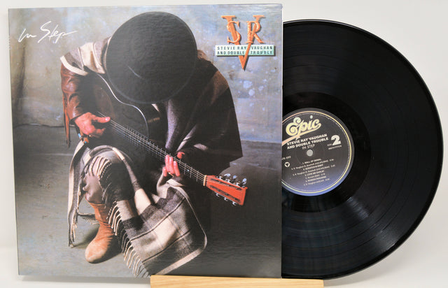 Vinyl record album shown with the front cover and a black LP disc partially pulled out. The cover features a seated figure holding a guitar, with the artist signature 'Jim Bowie' in the upper left and a stylized 'JB' logo in the upper right.