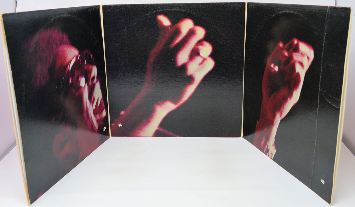 Album cover with a split-screen design showing a person's face and hands on a black background.