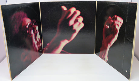 Album cover with a split-screen design showing a person's face and hands on a black background.