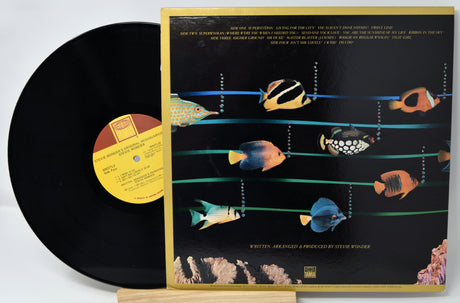 Vinyl record with a colorful fish illustration on the cover