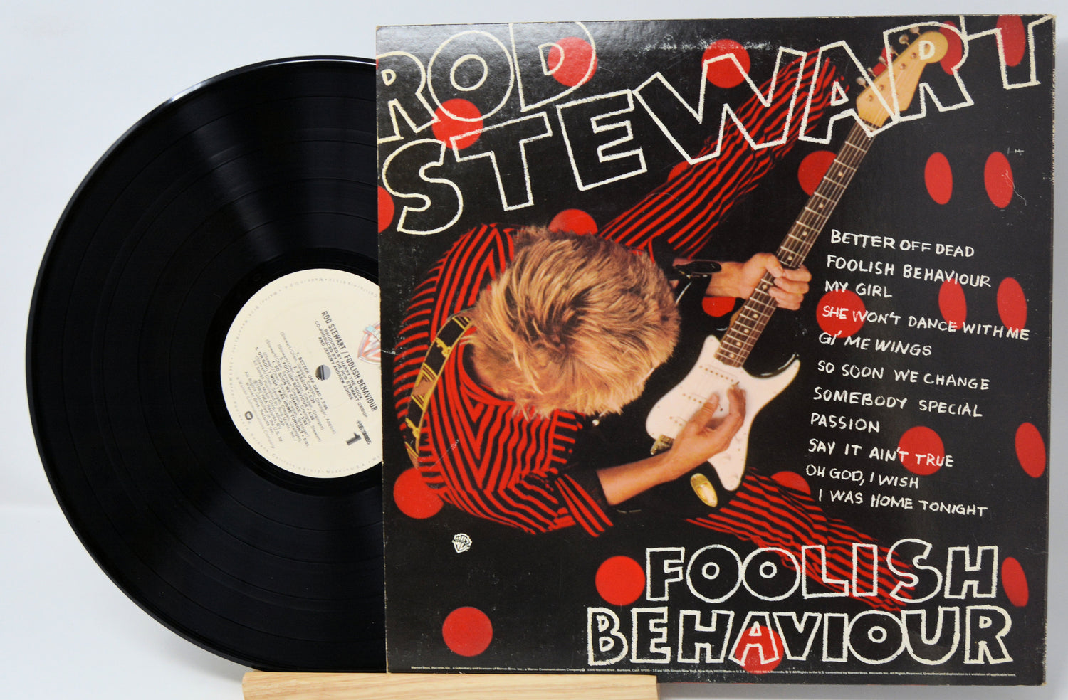 Vinyl record cover with a person and text on a beige background