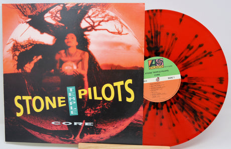 Vinyl record with 'Stone Temple Pilots' album cover showing a person and tree silhouette.