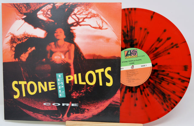 Vinyl record with 'Stone Temple Pilots' album cover showing a person and tree silhouette.