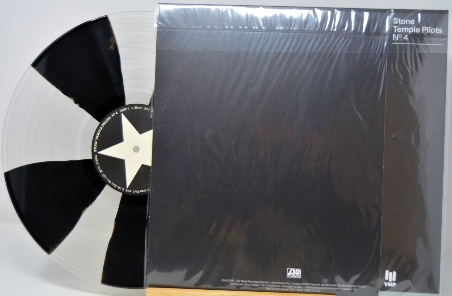'Stone Temple Pilots' vinyl record with a black and white star design on the label, next to its packaging.