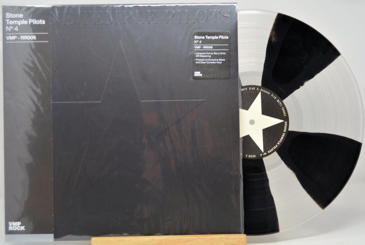 Vinyl record with a black and white star design on a clear disc, featuring the cover of 'Stone Temple Pilots' album.