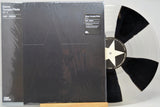 Vinyl record with a black and white star design on a clear disc, featuring the cover of 'Stone Temple Pilots' album.
