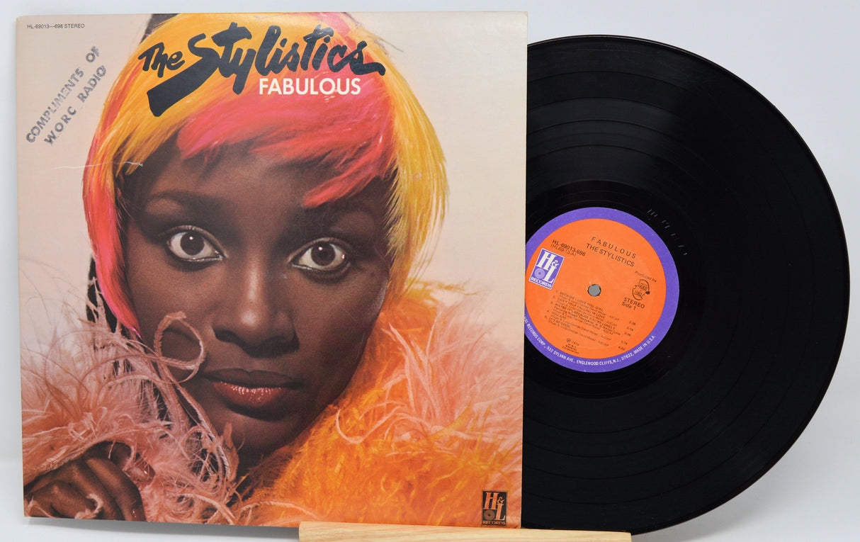 Vinyl record with a cover featuring a black and white photo of a person sitting outdoors.