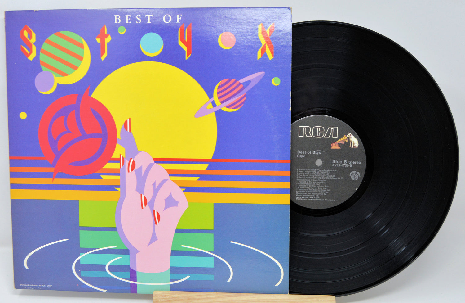 Vinyl record with colorful cover featuring abstract designs and text 'Best of'.