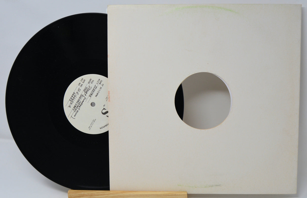 Vinyl record with a white label and a plain white record cover on a light gray background